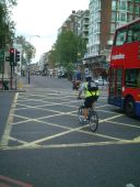 Matthew cycling along Gloucester Place, crossing the junction with Marylebone Road